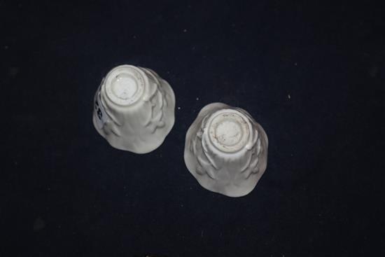 A pair of 18th century Chinese blanc de chine libation cups, wood stands